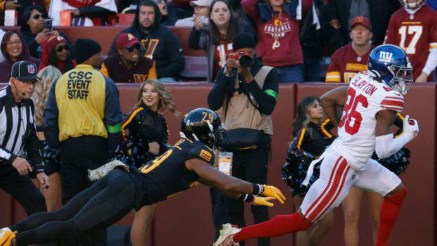 New York Giants wide receiver Darius Slayton (86) runs with the ball past Washington Commanders cornerback Kendall Fuller (29) en route to a touchdown during the second quarter at FedExField.